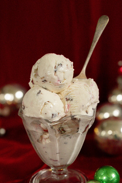 Ice cream sundae with Christmas ornaments on a red background