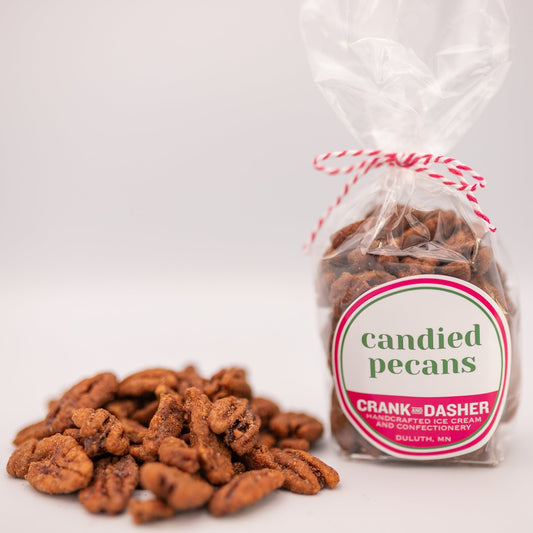 Bag of candied pecans with a label on a white background